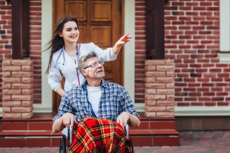 contented-senior-patient-with-kind-doctor-nursing-home-time-together-scaled